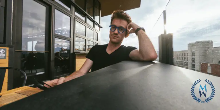 man looking into camera at outdoor rooftop bar