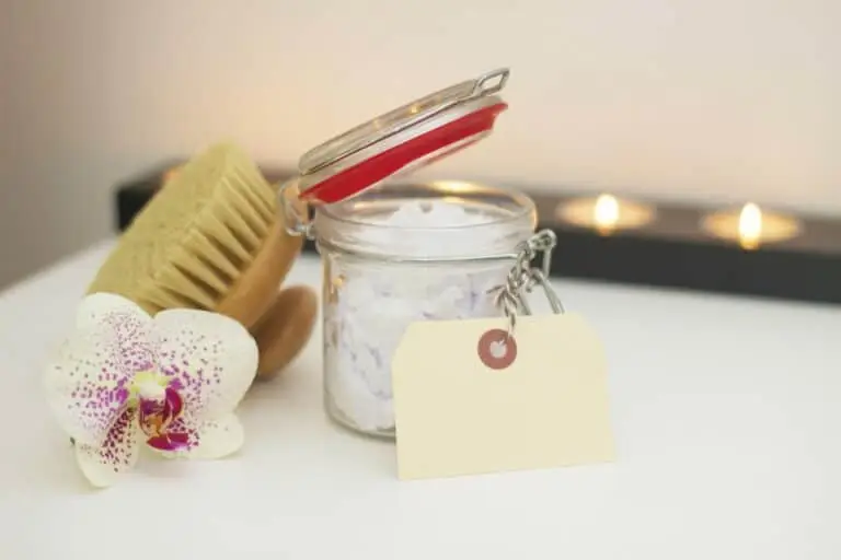 jar of bath essentials next to flower