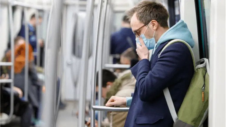 man with mask on subway