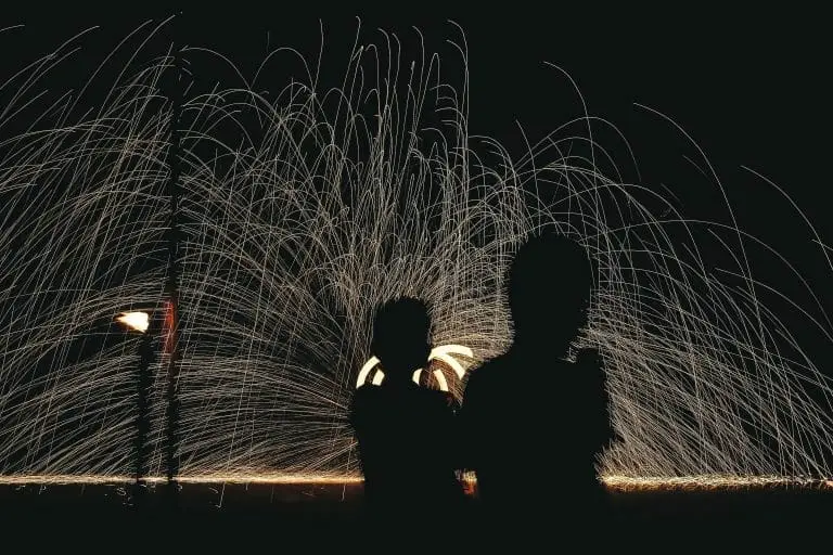 shadows of kids in front of fireworks