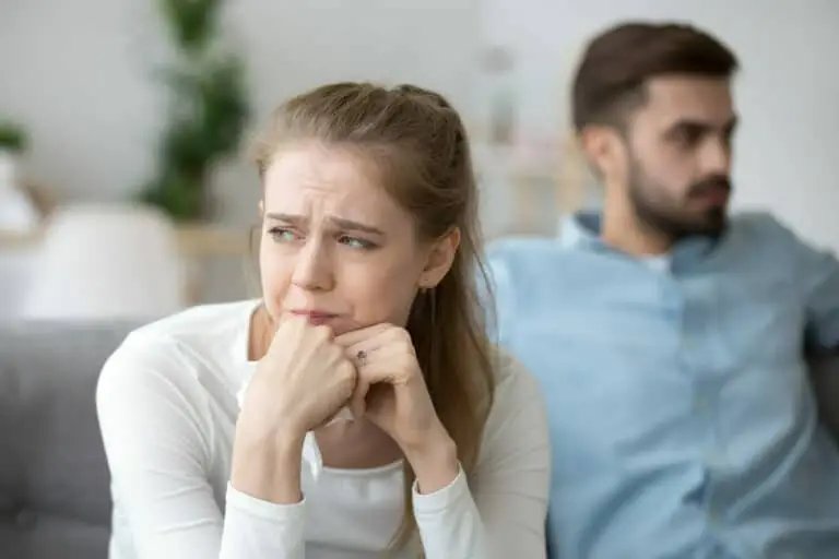 A couple sitting on the couch, facing opposite directions due to issues with relationship Insecurity