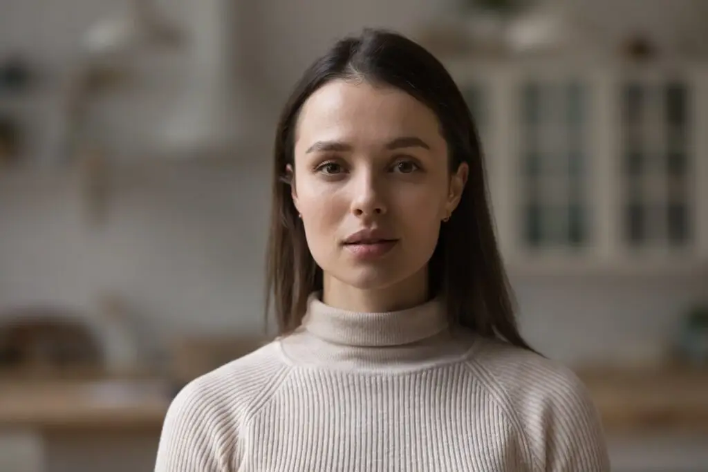 A woman looking forward saddened and distressed by her mental health symptoms.