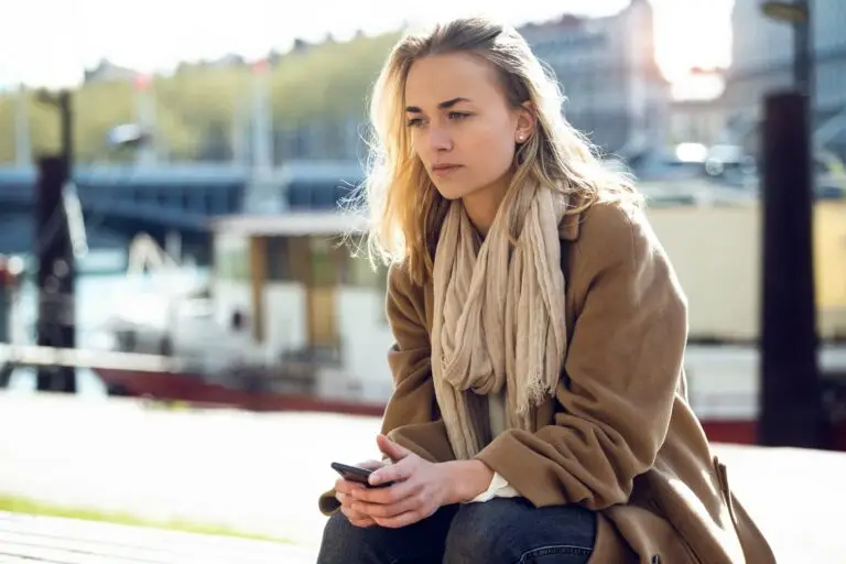 woman sitting with her hands in her lap looking sad and depressed