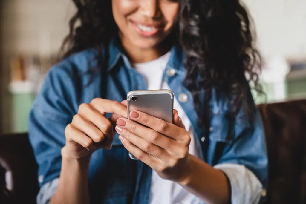 young happy woman texting on her phone