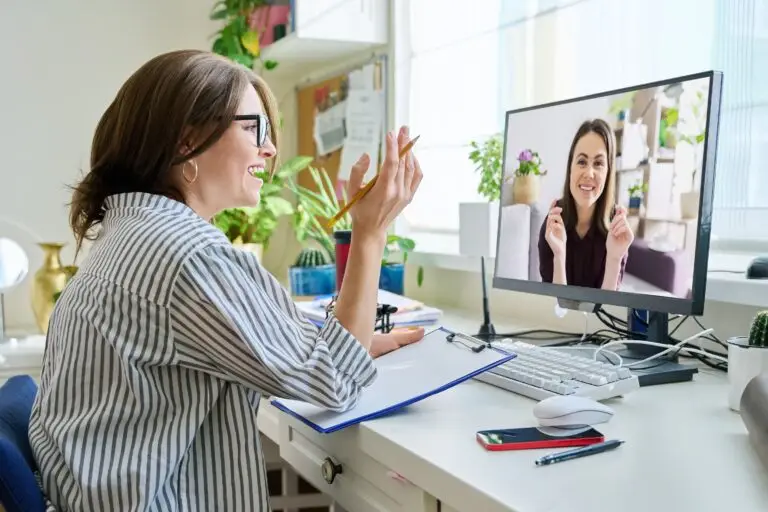 an online mental health therapist is in her bright office meeting with her client through a video call session