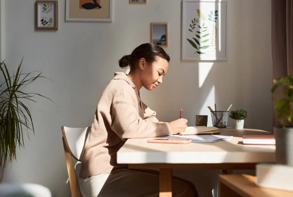 a young woman sitting at her desk putting to use coping skills for anxiety to destress and relax