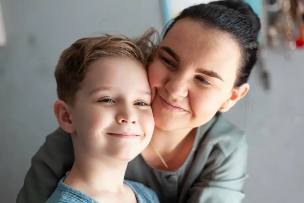 A mother and son hug each other happily as the mom is learning more about how to get an autism diagnosis for him. This will open the door for both of them to receive the unique care her son needs.