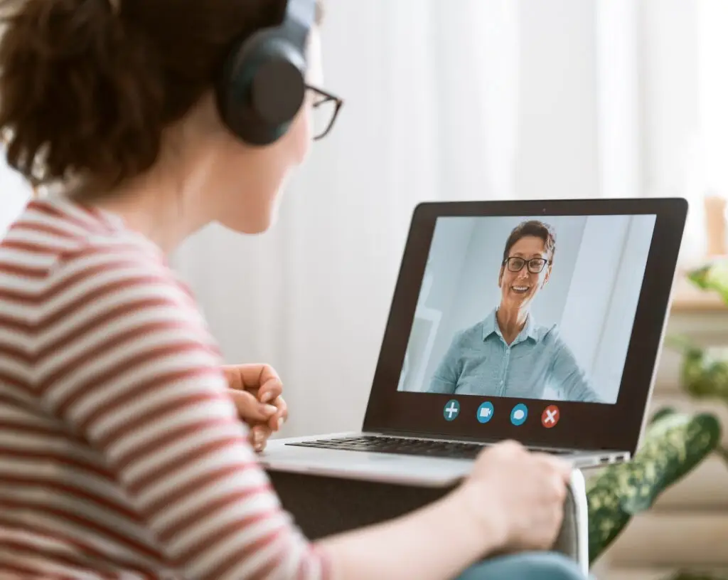 Woman talking with her online therapist on a video chat session on her laptop.