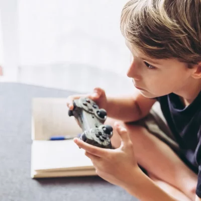 a young boy playing video games while he copes with stress and ignores his responsibilities.