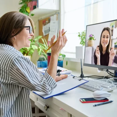 an online mental health therapist is in her bright office meeting with her client through a video call session